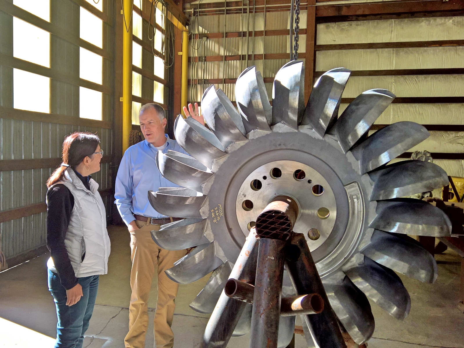 Congresswoman Suzan DelBene next to a wind turbine